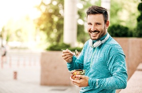 Man enjoying salad with help of dental implants