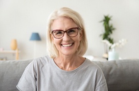 Smiling senior woman enjoying results of All-on-4 in New Haven