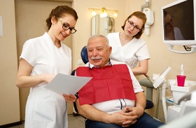 Senior man’s consultation for All-on-4 dental implant treatment
