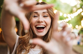 Happy woman enjoying benefits of dental implants in New Haven