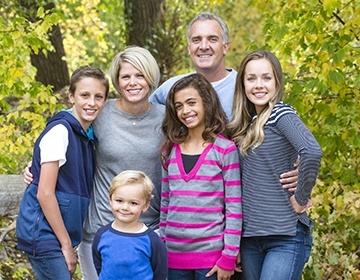 Smiling family of six outdoors