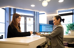 Happy patient interacting with dental team member