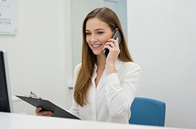 Patient and dentist enjoying a friendly conversation