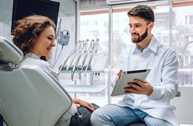 Dentist and patient discussing tooth replacement treatment options