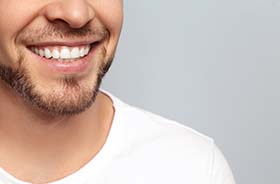 Closeup of smiling man after toothache treatment in New Haven