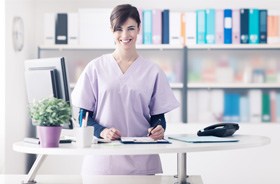 Dental team member standing behind desk