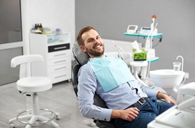Dental patient smiling after dental implant salvage procedure