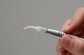 hand holding dental laser