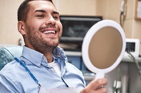 happy dental patient with mirror