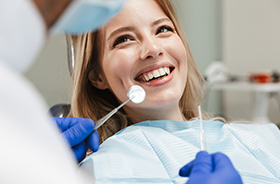 female patient talking to dentist before periodontal exam