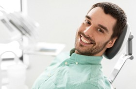 Happy patient at checkup for his dental implants