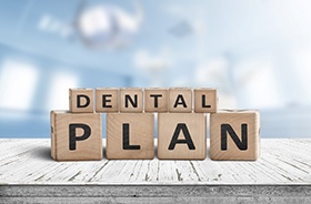 Dental plan written on wooden blocks, sitting on tabletop