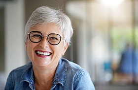 Smiling senior woman, happy she invested in dental implants