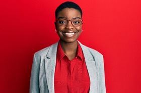 Smiling patient, happy she followed dental implant post-op instructions in New Haven