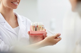 Dentist explaining the merits of antibacterial coatings on implants