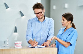 Dental patient learning about his options for paying for Invisalign