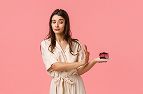 Attractive woman saying no to slice of cake