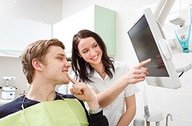 Dentist and patient looking at dental x-rays