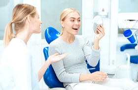 patient admiring her smile