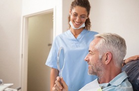 happy dental patient with mirror