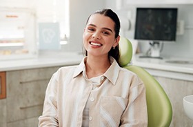 Happy dental patient in treatment chair