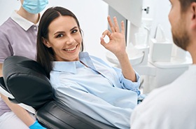 Dental patient using her hand to make OK sign