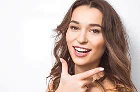 Beautiful woman showing her smile with veneers in New Haven