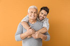 Father and adult son, both possible candidates for dental implants