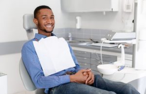 Smiling man at appointment to maximize dental insurance benefits