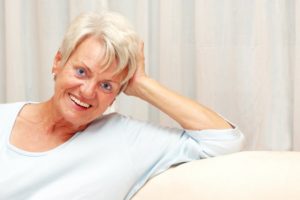 Senior woman benefitting from modern evolution of dentures