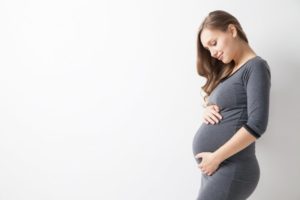 Woman wondering about getting dental implants during pregnancy