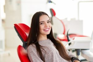 Smiling patient at appointment to use her dental insurance