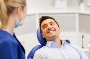 Smiling patient, glad to know root canals in New Haven are not painful