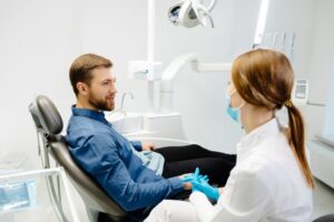 Dentist and patient talking in treatment room